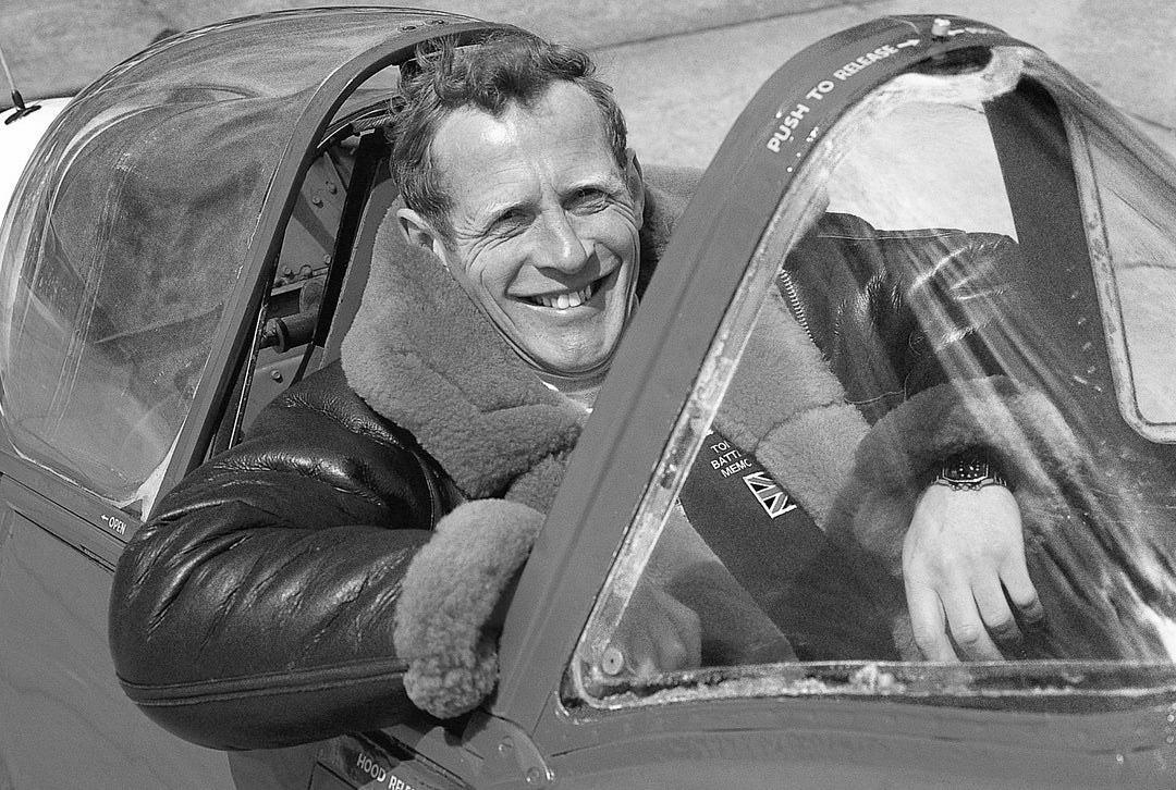Tony Banfield sitting in an aeroplane cockpit with a smile on their face
